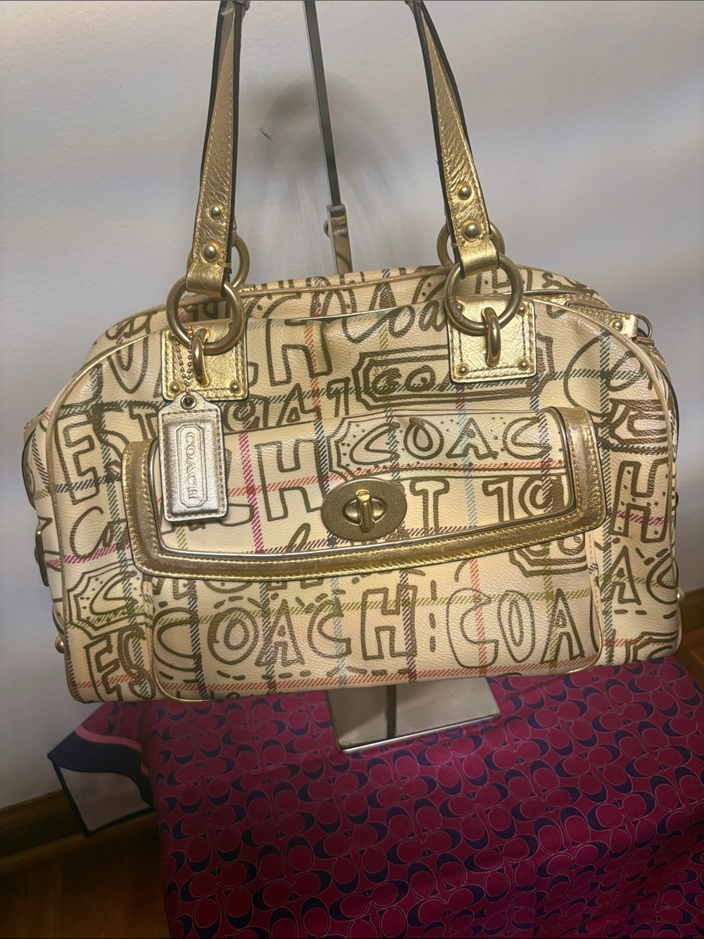 Coach Poppy Graffiti Tattersall Satchel featuring a cream graffiti script print